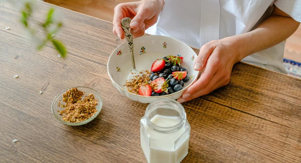 Yogurt, berries, and nuts on a plate