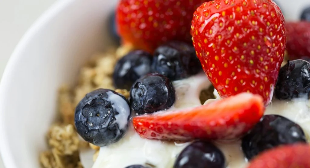 Greek yogurt bowl with fruit, oats, and food picks