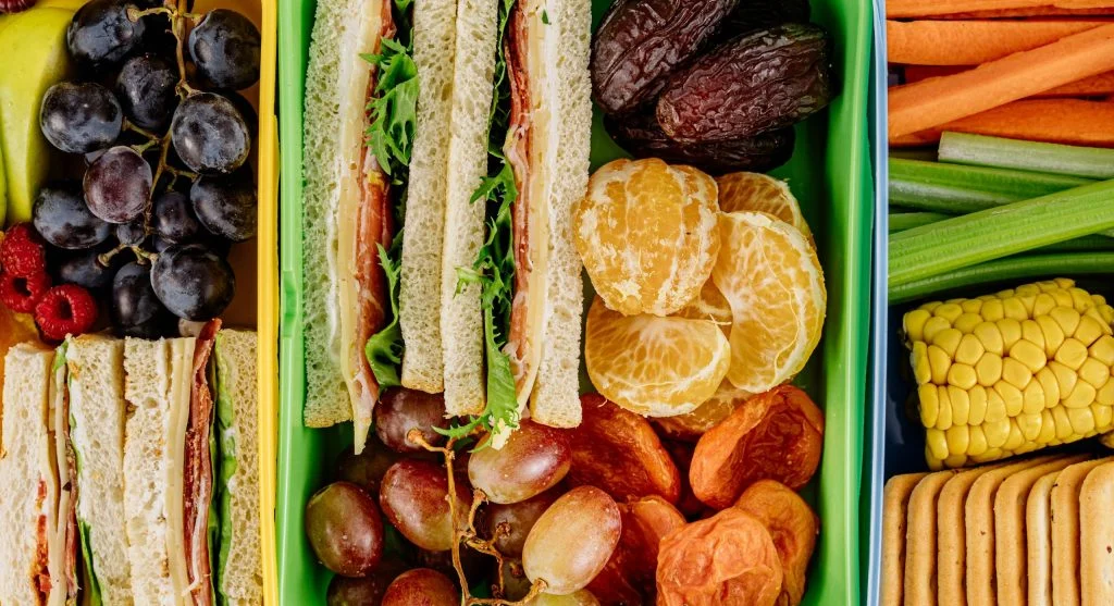 Food picks including crackers, apple, and yogurt to enhance a soup lunch
