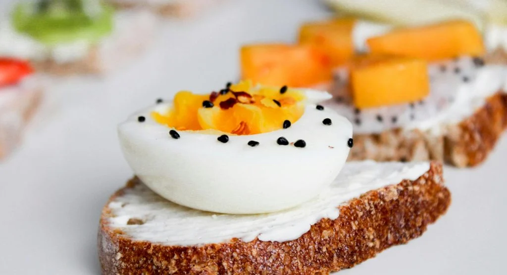 Food picks for a healthy dinner with eggs, toast, fruit, and yogurt sauce